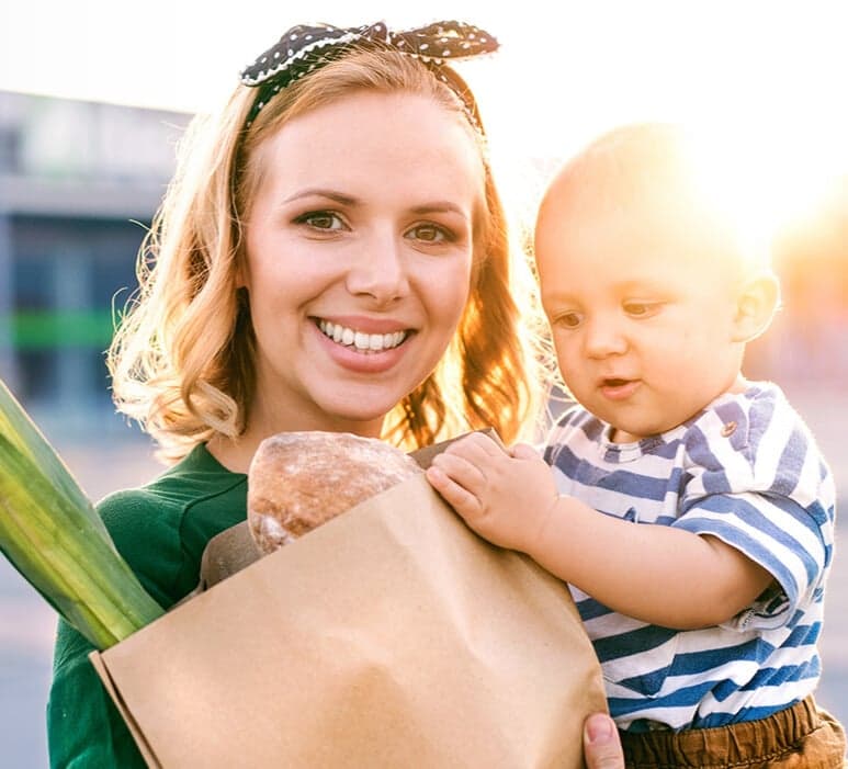 women with child and groceries